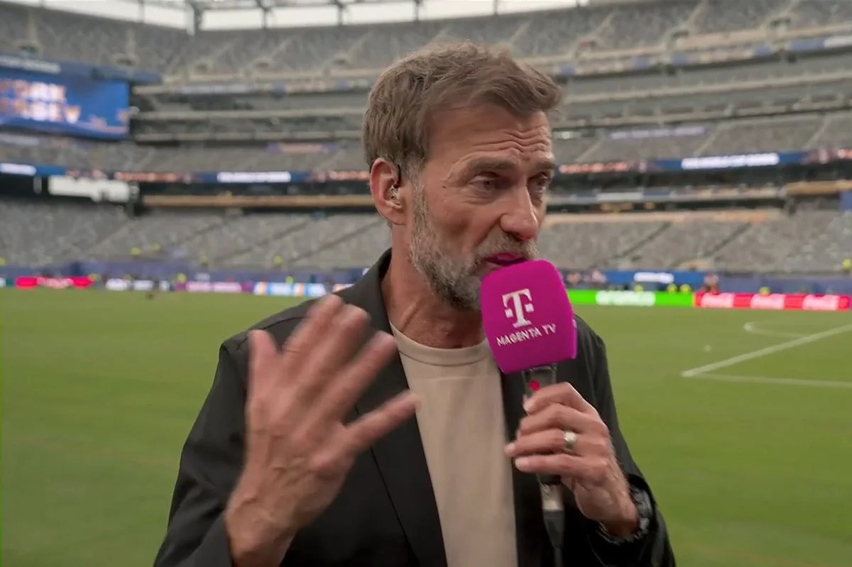 Jurgen Klopp speaking into a microphone at the World Cup